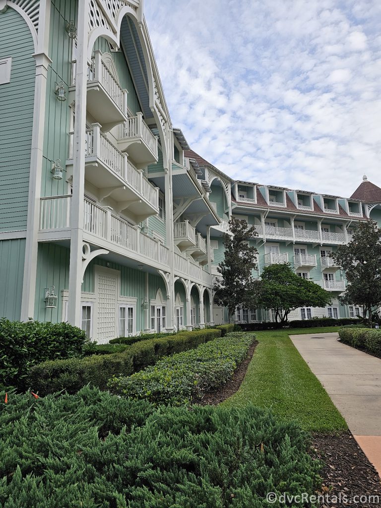 Exterior Shot of Disney's Beach Club Villas and a walking path in front of the building.