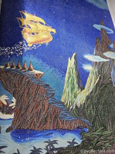 Tiles in the Peter Pan mural depicting a golden pirate ship flying over Neverland.