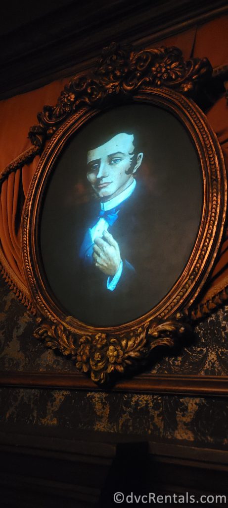 Master Gracey's portrait above the mantel in the beginning of the Haunted Mansion.
