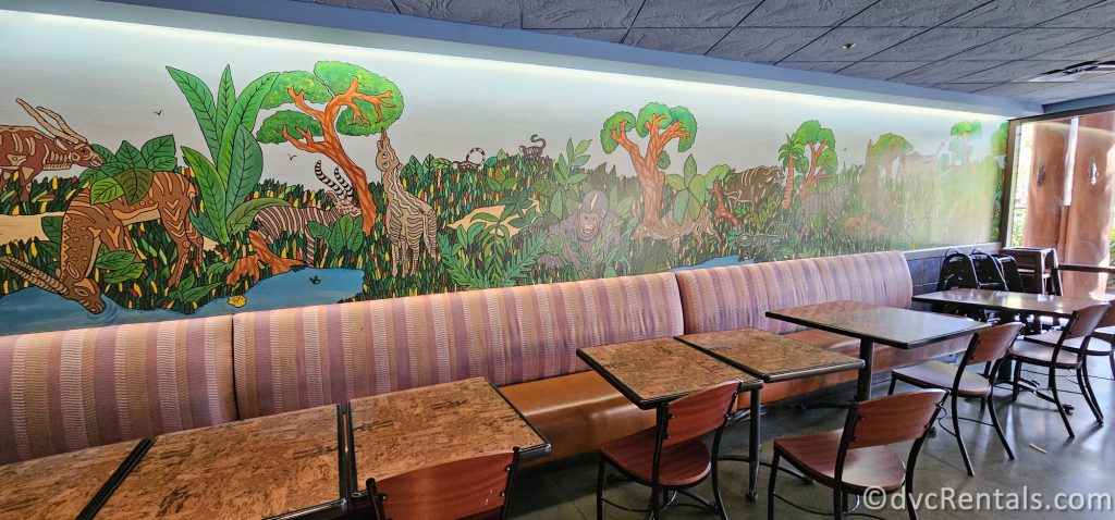 Interior of The Mara. A mural of Savanna animals is painted on the walls of the restaurant.