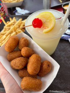 An order of Corn Dog Nuggets sitting next to a Frozen Mint Julep and an order of fries.