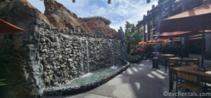 A Waterfall feature behind the exterior seating area at Trader Sam's Tiki Terrace.