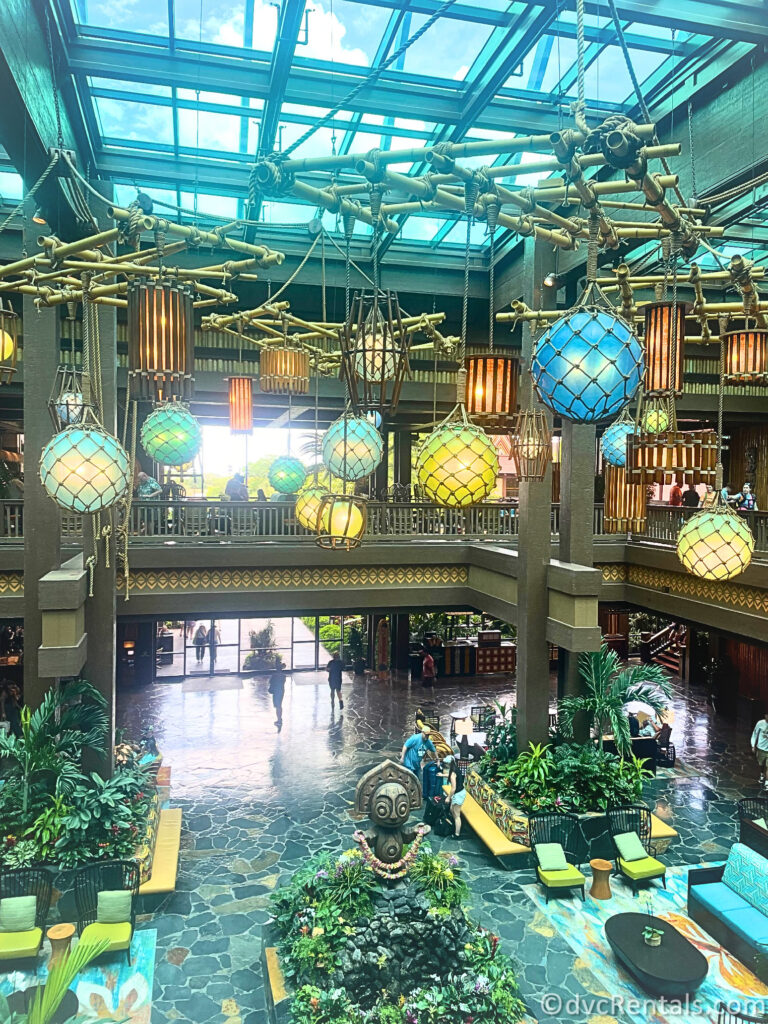 Overhead shot of Disney's Polynesian Villas lobby. A large Tiki Statue sits in the middle of the lobby.