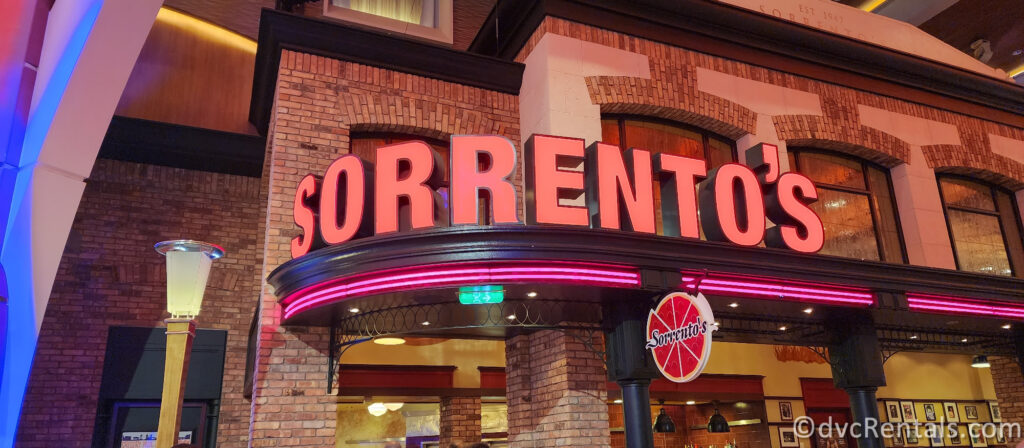 Neon Red Sign for Sorrento's with a pizza sign next to it.