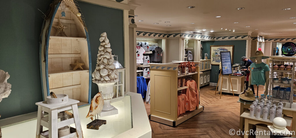 Merchandise in the Resort Gift Shop at Disney's Beach Club Villas. There are multiple displays throughout the shop with light wood and sea shell sculptures around the displays.
