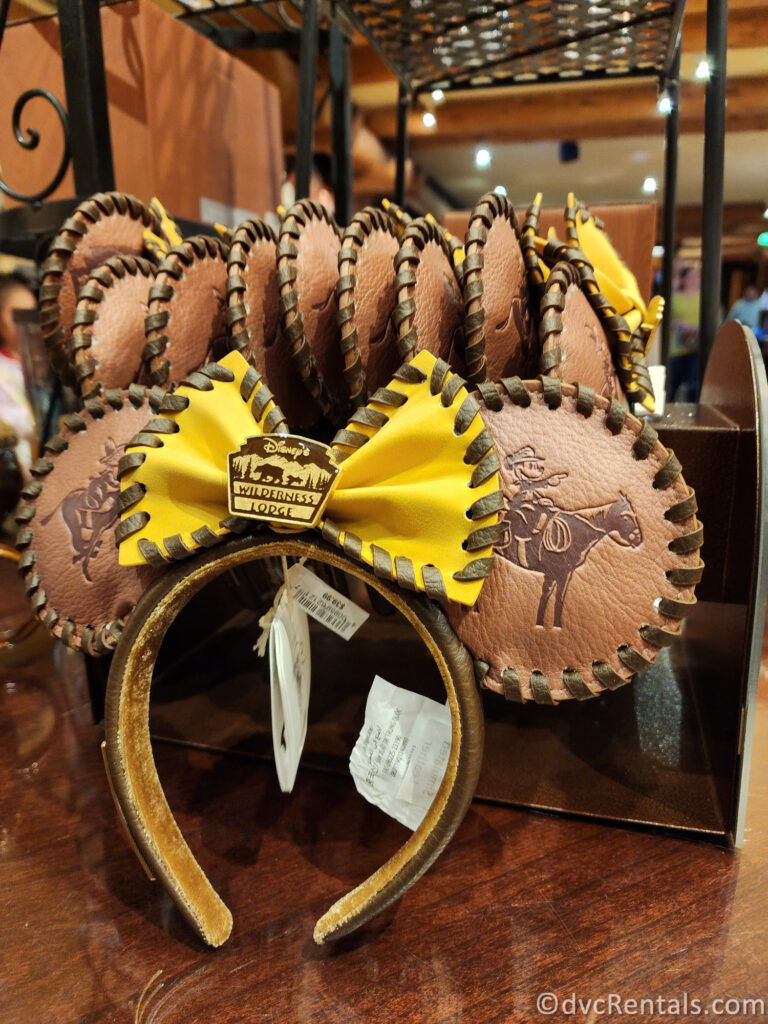 Display of brown leather Wilderness Lodge Minnie Ears sitting on a table.