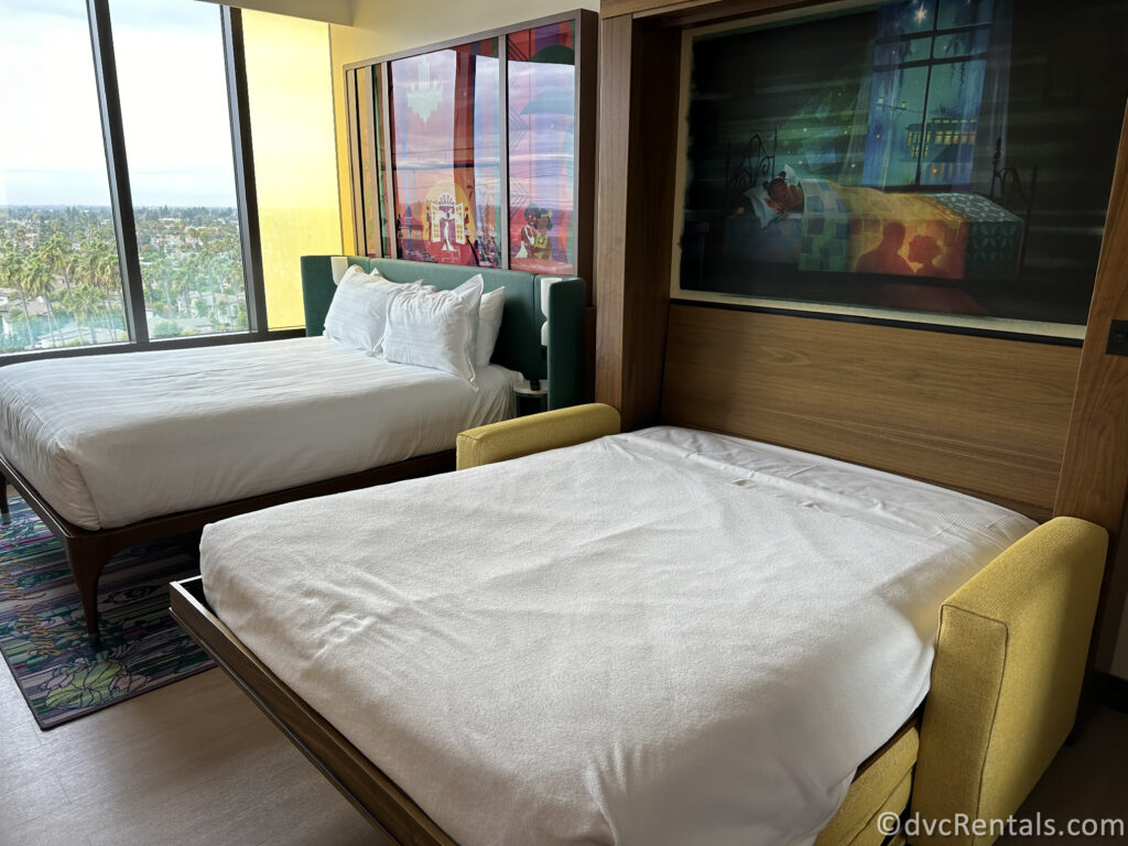 Second bedroom layout in a two bedroom villa. There is a queen-sized bed and a pull-down bed.