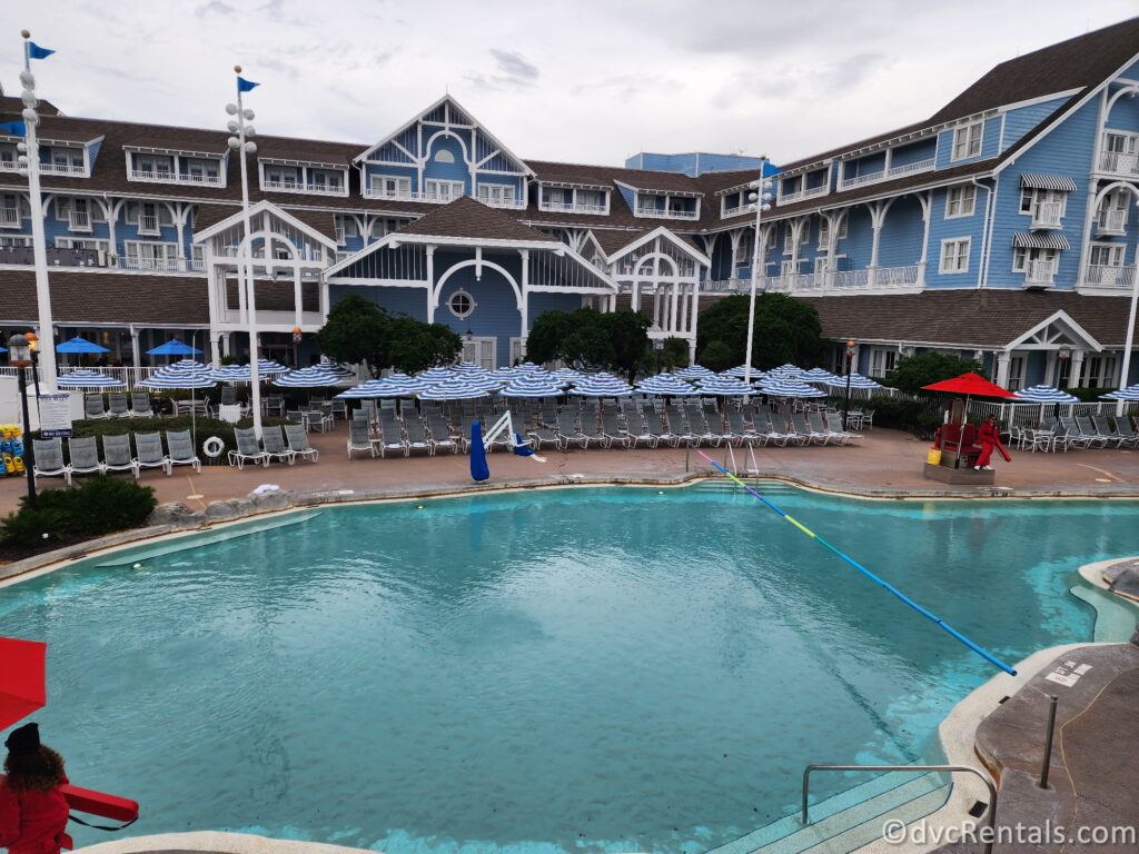 Pool at Disney's Beach Club Resort with the bright blue resort building in the background.