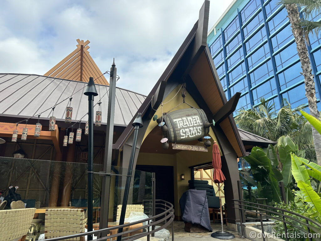 Exterior of Trader Sam's Enchanted Tiki Bar. There is a patio off the Tiki Bar and lanterns hanging overhead.