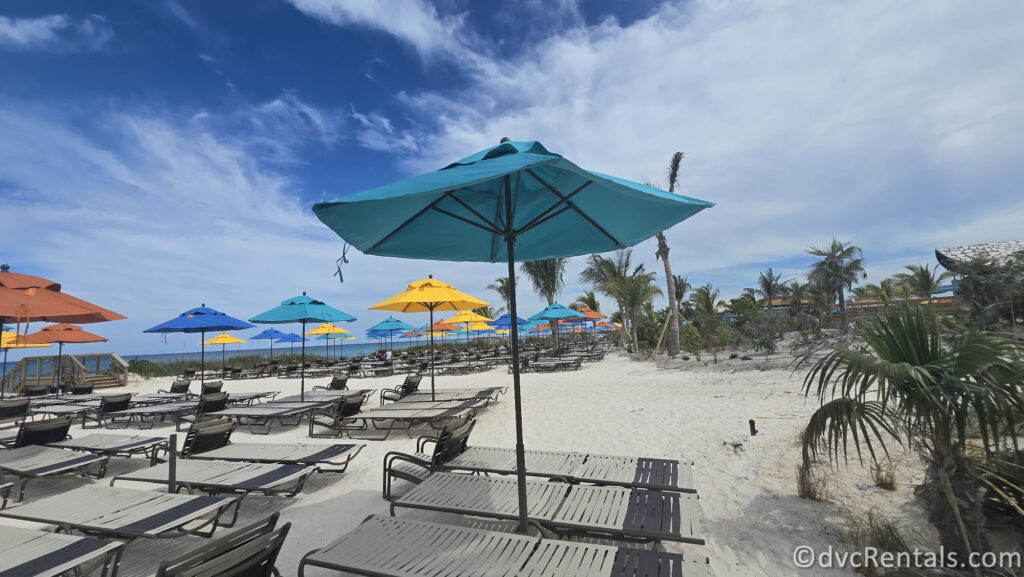 Beach Seating with colorful umbrellas sprawled along the white sand.