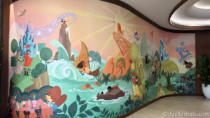 Mural in the lobby of The Villas at Disneyland Hotel showcasing many Disney characters interacting together.