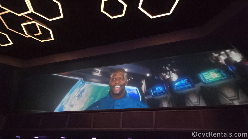 Terry Crews as Tal Marik on a screen in the pre-show for Guardians of the Galaxy: Cosmic Rewind.