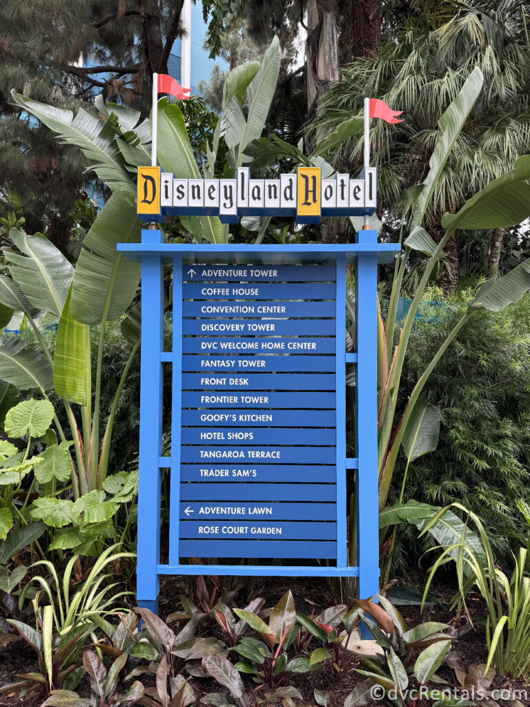 Blue Metal Directional Sign that reads "Disneyland Hotel" at the top and points towards other areas of the resort.