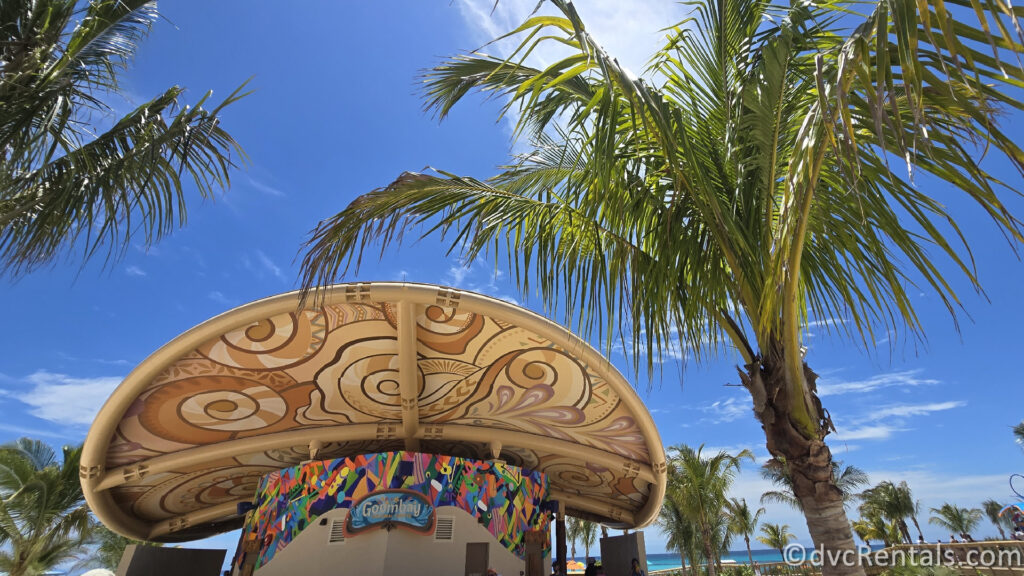 Exterior of Goombay Cultural Center with a large palm tree next to it.