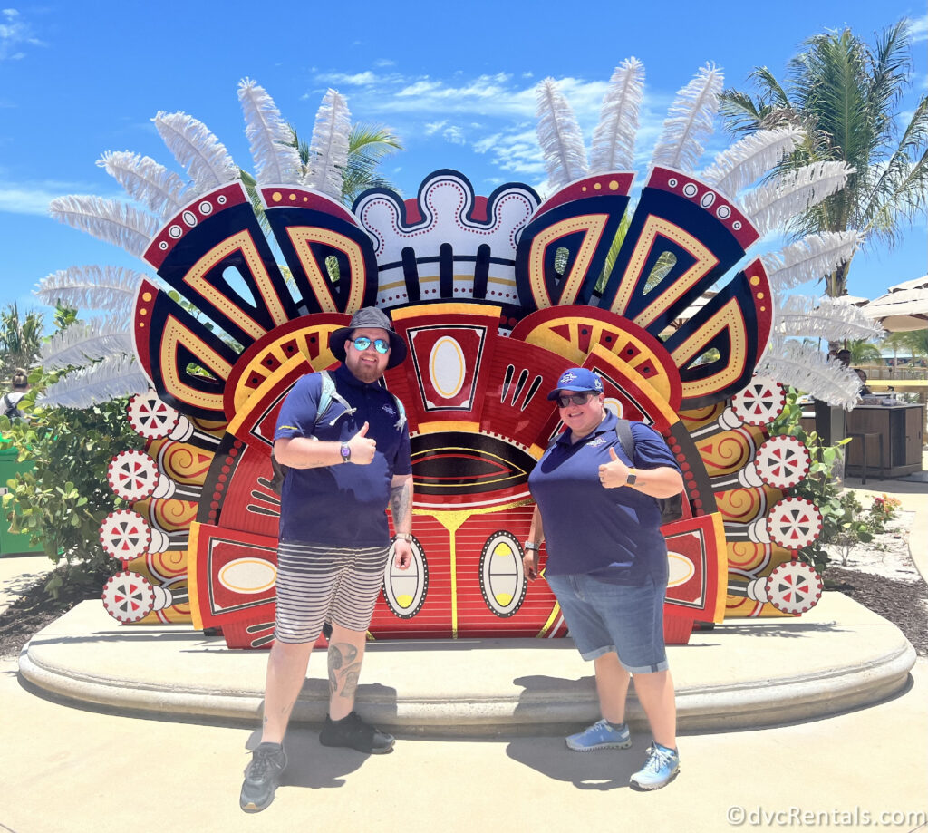 Team Members Nick and Lindsay standing in front of a large red Mickey Mouse display on Lookout Cay.