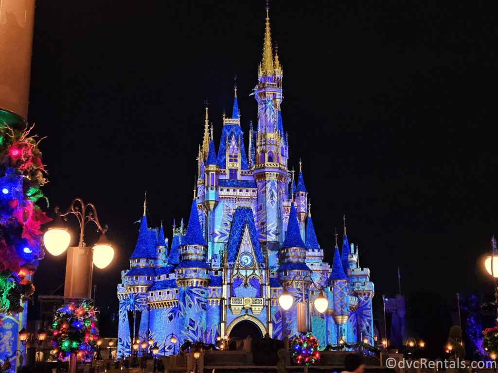 Cinderella Castle at Magic Kingdom covered in snowflake projections.