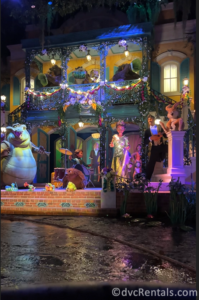 Final party at Tiana and Naveen's house. Animatronics or Tiana, Louis, Naveen, and the critter band can be seen standing in front of a large New Orleans house.