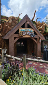 Exterior of Critter Co-op. The wooden entrance is built into a large rock.