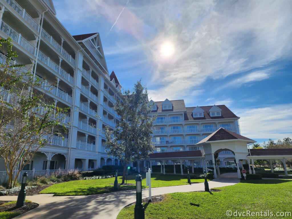 Exterior of Disney's Grand Floridian Resort and Spa. Large White Victorian-looking building with pink accents.