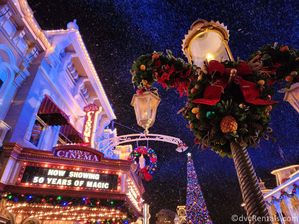 Christmas Decorations on Main Street U.S.A. in Magic Kingdom with fake snow falling from the night sky.