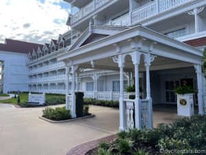 Exterior of Big Pine Key building at Disney's Grand Floridian. Large White Victorian-looking building with pink accents.