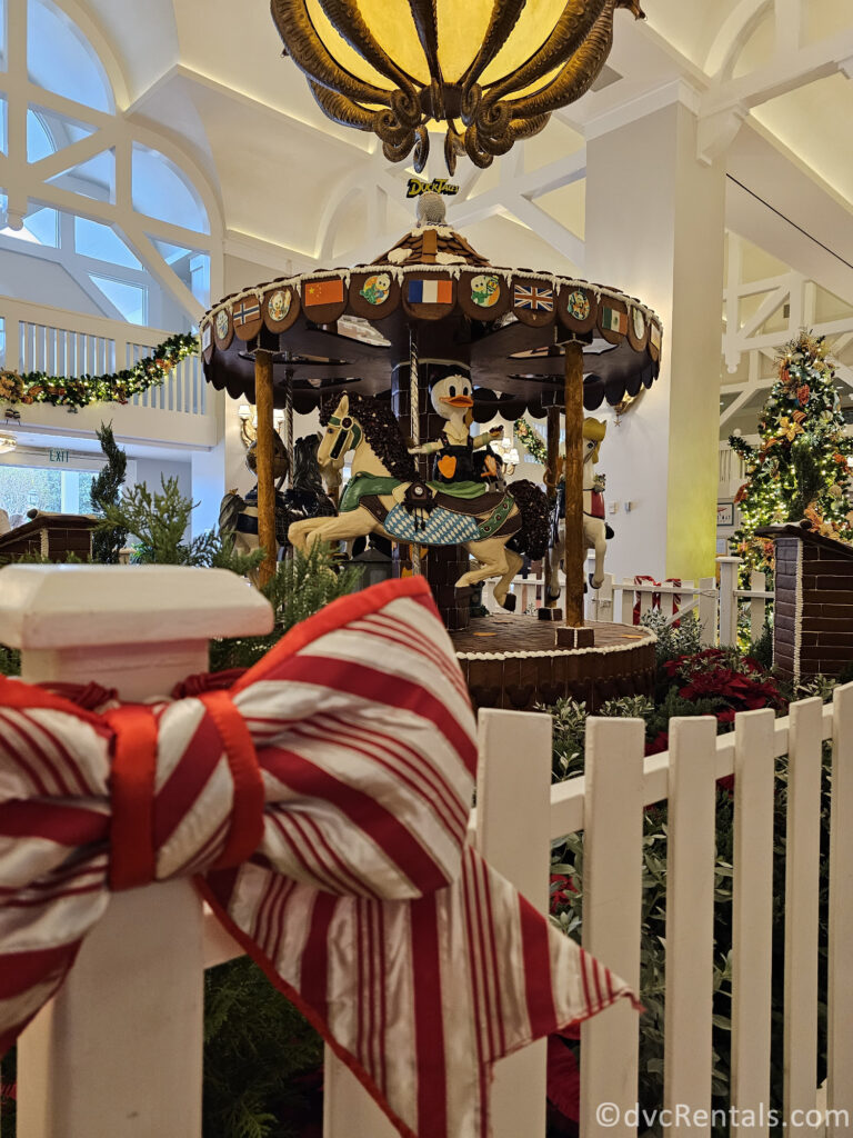 Gingerbread Carousel in the lobby of Disney's Beach Club Resort. A gingerbread Donald sits on top of one of the horses on the carousel.