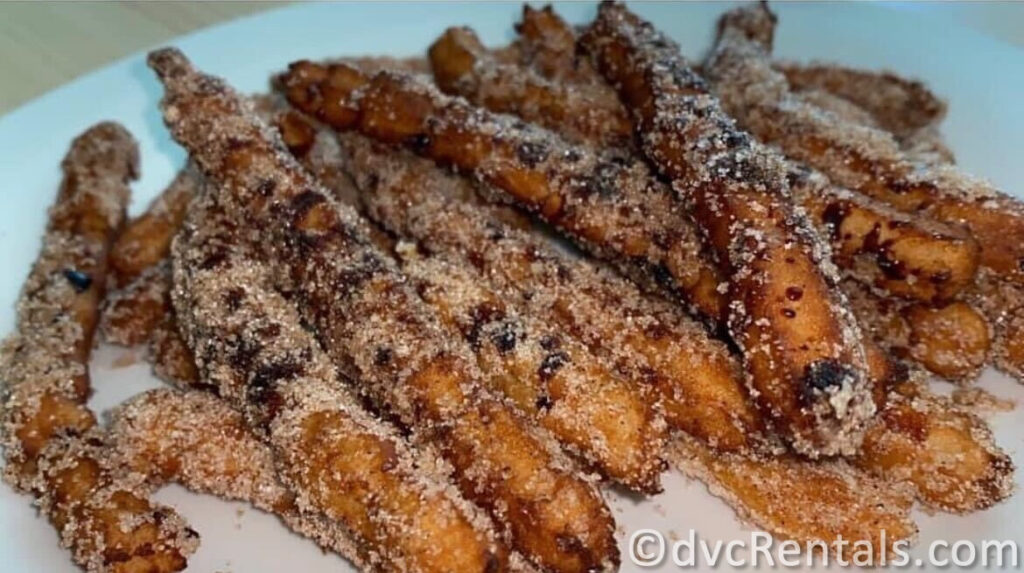 Pile of Mya's Homemade Churros covered in Cinnamon Sugar.