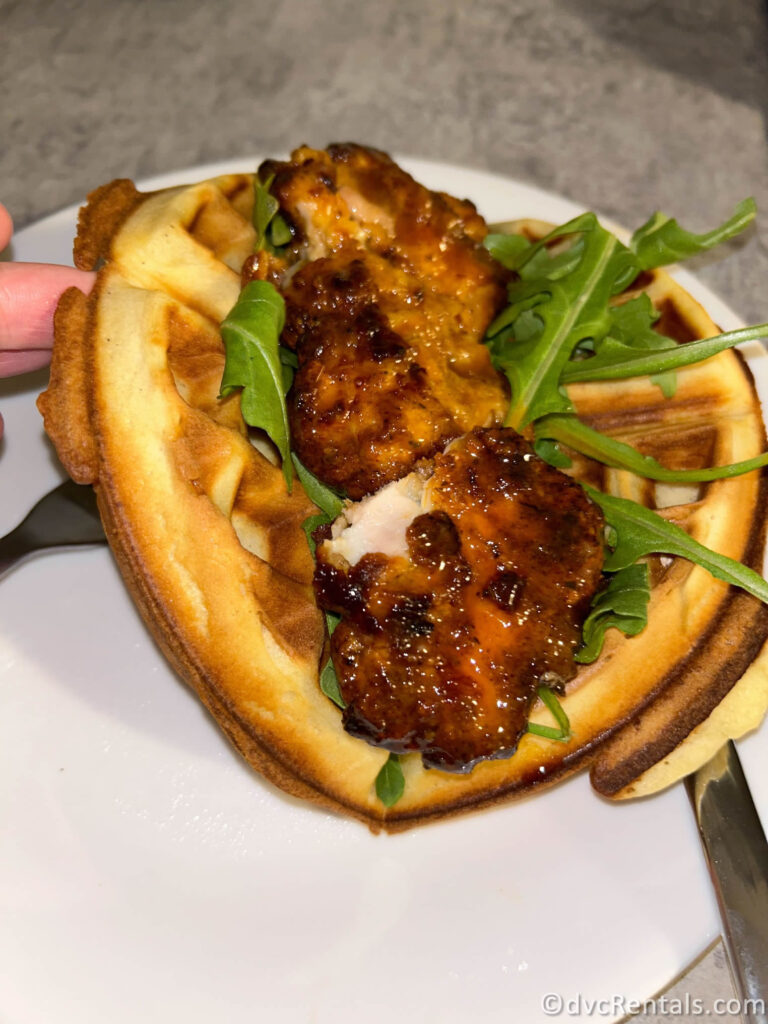 Mya's Homemade Waffle topped with Glazed Chicken and Arugula.