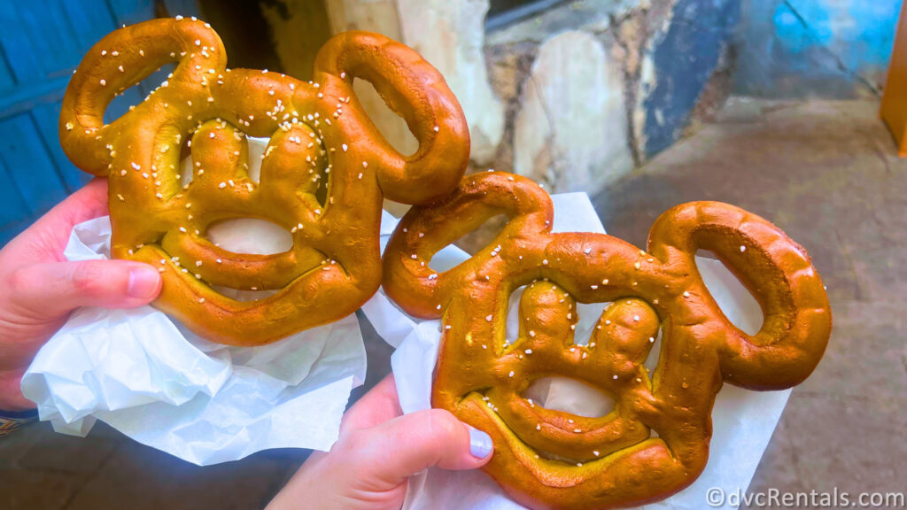 Two Mickey Mouse-shaped Pretzels being held in Disney's Hollywood Studios.