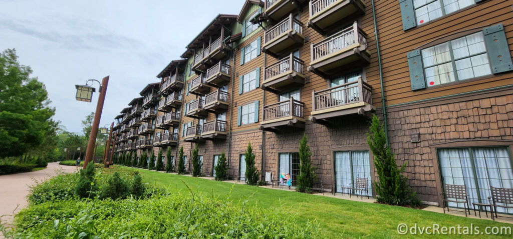 Exterior of Boulder Ridge Villas. The building is made of wood and has balconies overlooking a grassy area.