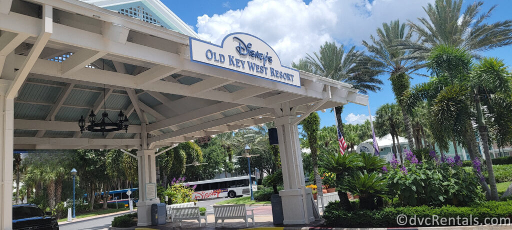 The entrance to Disney's Old Key West Resort. The structure has a white wooden frame with light blue accents and a sign that reads "Disney's Old Key West Resort."