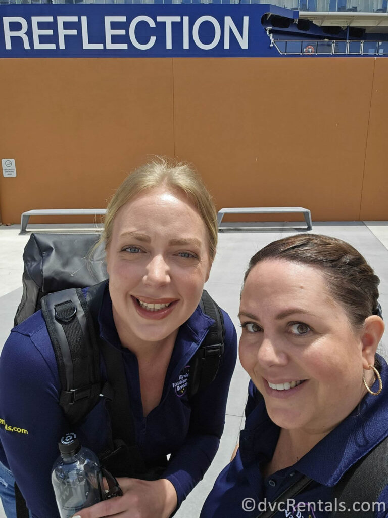 Team Members Stacy and Maddie smiling in a selfie in front of the Celebrity Reflection.