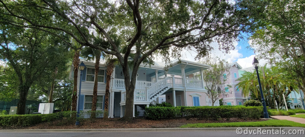 A two-story building at Disney's Old Key West Resort, designed in a pastel color scheme with light blue and white tones.