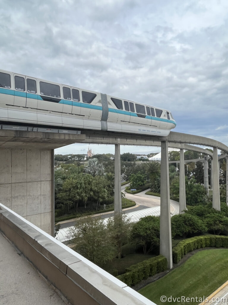 Blue and white monorail entering in Disney's Contemporary Resort.