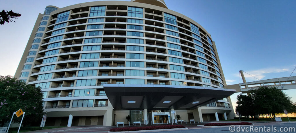 Exterior of Bay Lake Tower at Disney's Contemporary Resort. The building has a light-colored facade and a prominent entrance with a covered walkway.