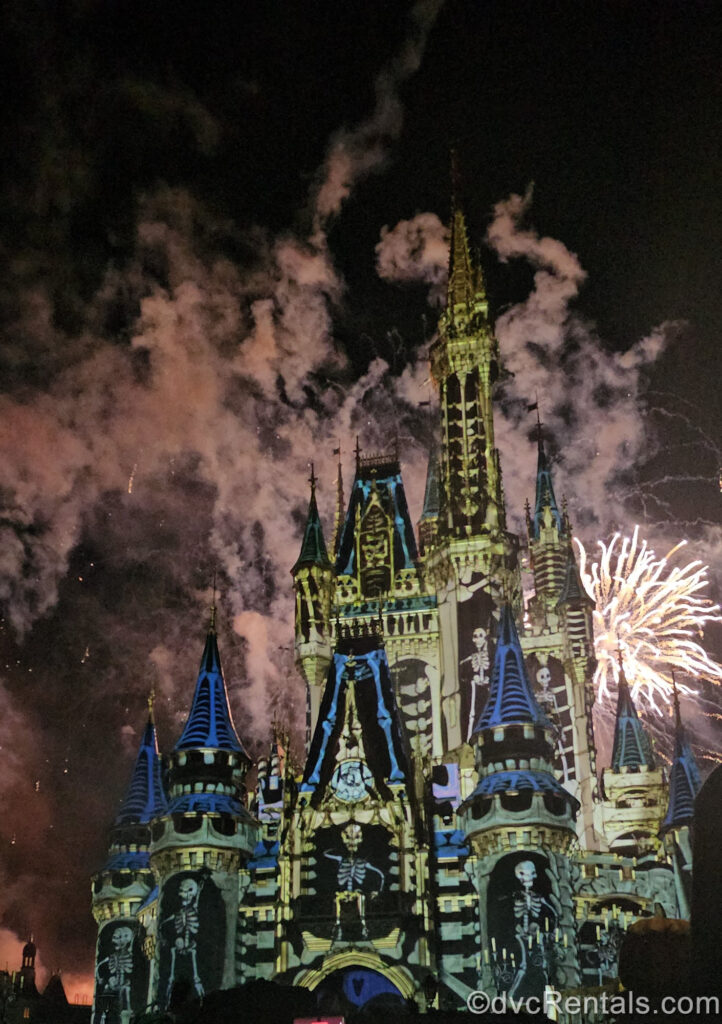 Cinderella Castle is illuminated by white fireworks as well as white skeleton special effects projections during Disney’s Not-So-Spooky Spectacular at Magic Kingdom.