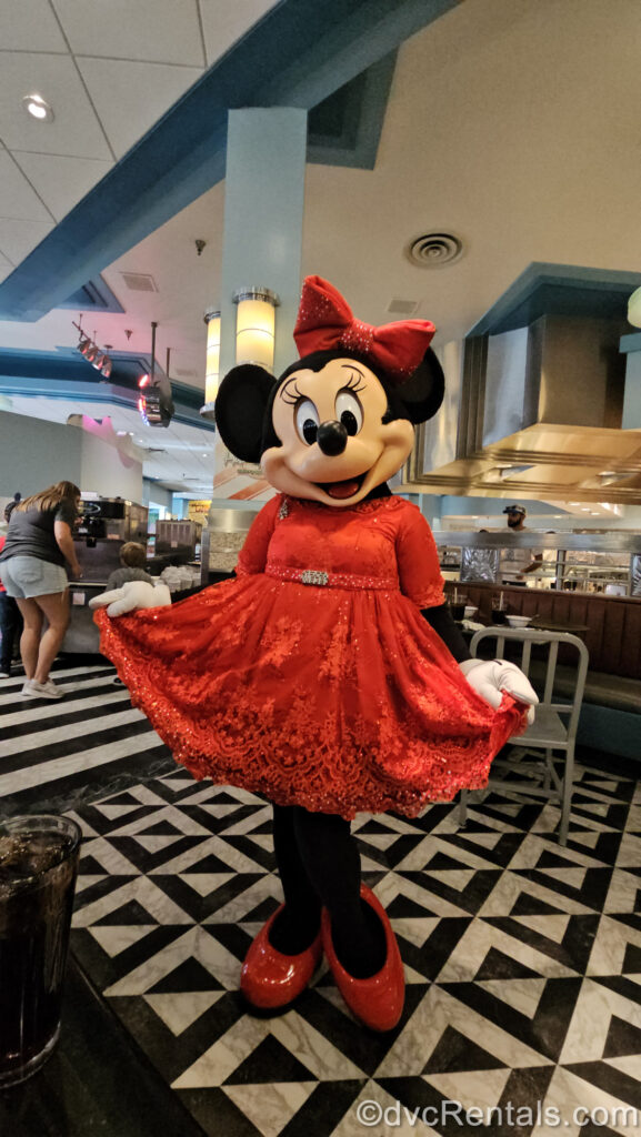 Minnie Mouse wears her sparkly, red lace holiday dress at Hollywood & Vine restaurant at Disney’s Hollywood Studios.