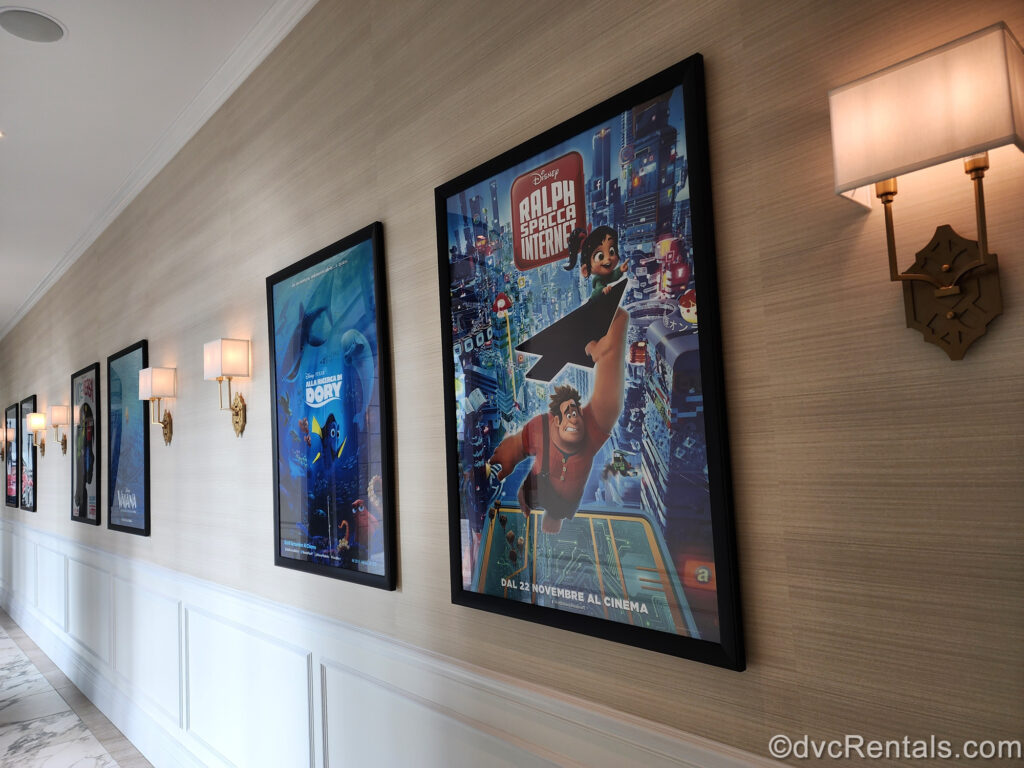 International movie posters line a hallway wall at Disney’s Riviera Resort. The posters feature the Italian and French titles and tag lines for Disney animated films such as Finding Dory, Moana, and Ralph Breaks the Internet.