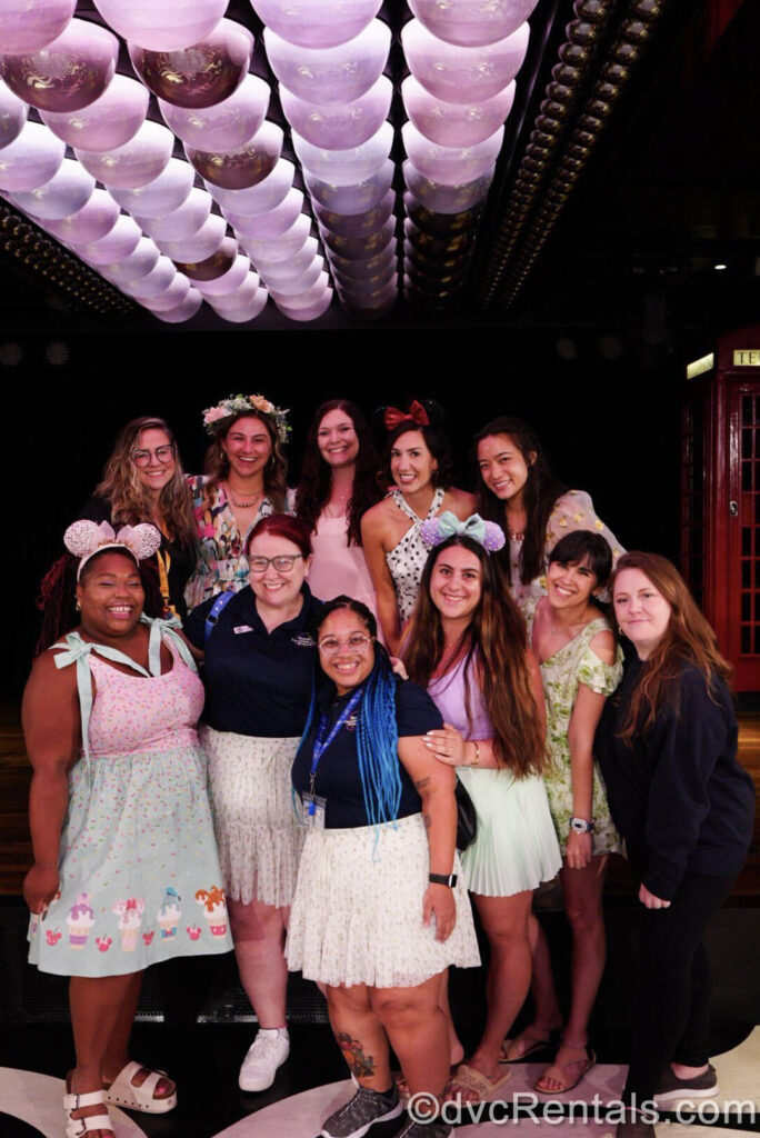 David’s Vacation Club Rentals team members Kristen and Mya pose in a group smile with a number of Disney Influencers and Content Creators while sailing on the Disney Fantasy.