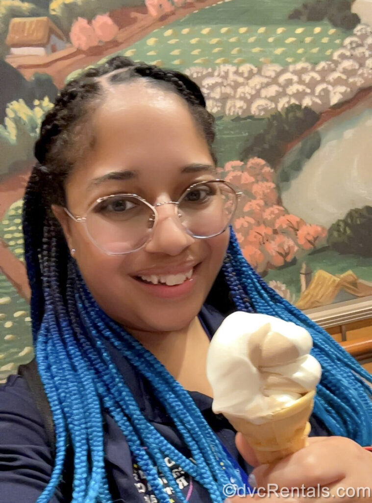 David’s Vacation Club Rentals team member Mya poses with a smile and a soft-serve ice cream cone on the Disney Fantasy.