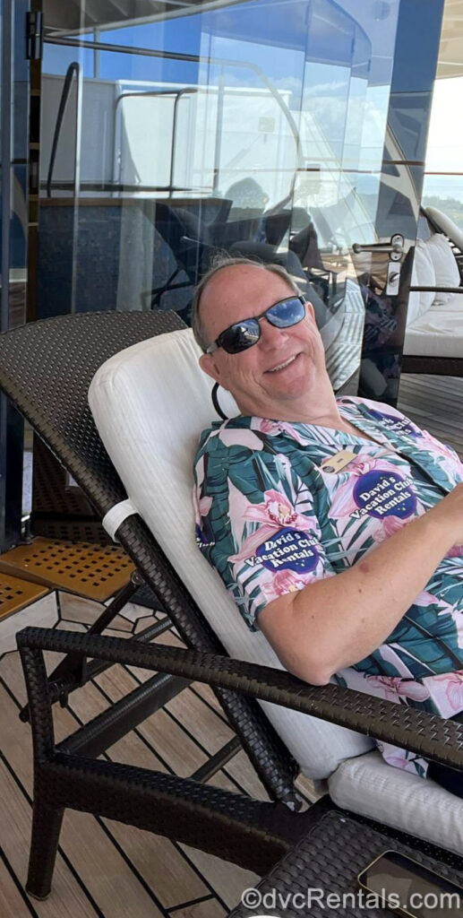 David Mullet, the owner and president of David’s Vacation Club Rentals poses with a smile while relaxing on a lounger on the Disney Fantasy.