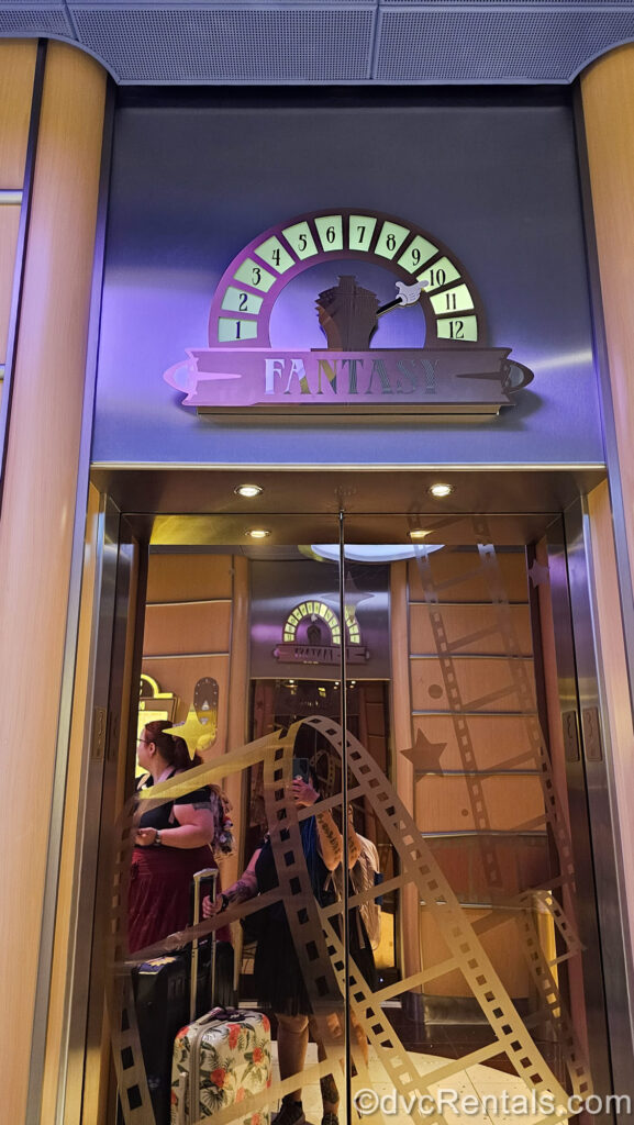 The exterior of an elevator on the Disney Fantasy. The floor indicator is a miniature ship with Mickey’s hand pointing at the deck number the elevator is currently at.