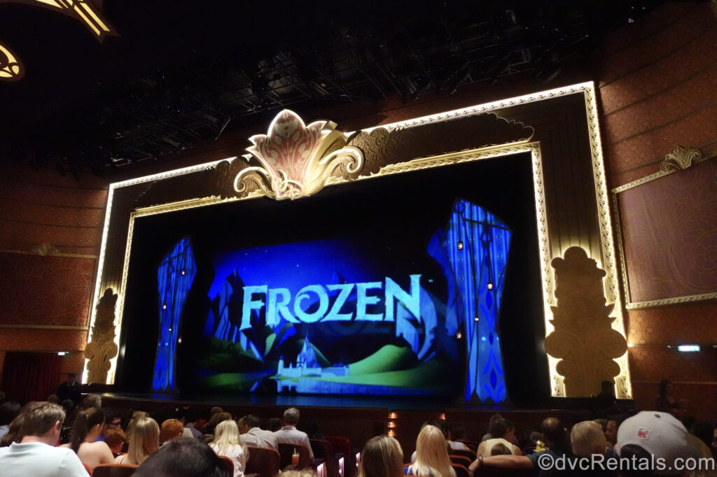 The stage in the Walt Disney Theatre is set for a production of Frozen, A Musical Spectacular as the audience awaits the show beginning.