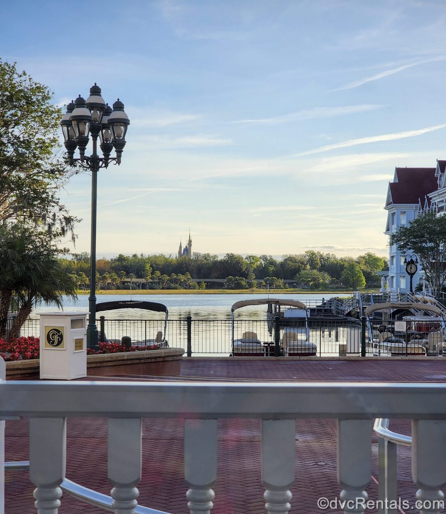 Cinderella Castle at Magic Kingdom is seen under a Golden Hour sky from across the Seven Seas Lagoon and the grounds of Disney’s Grand Floridian Resort & Spa are also shown.