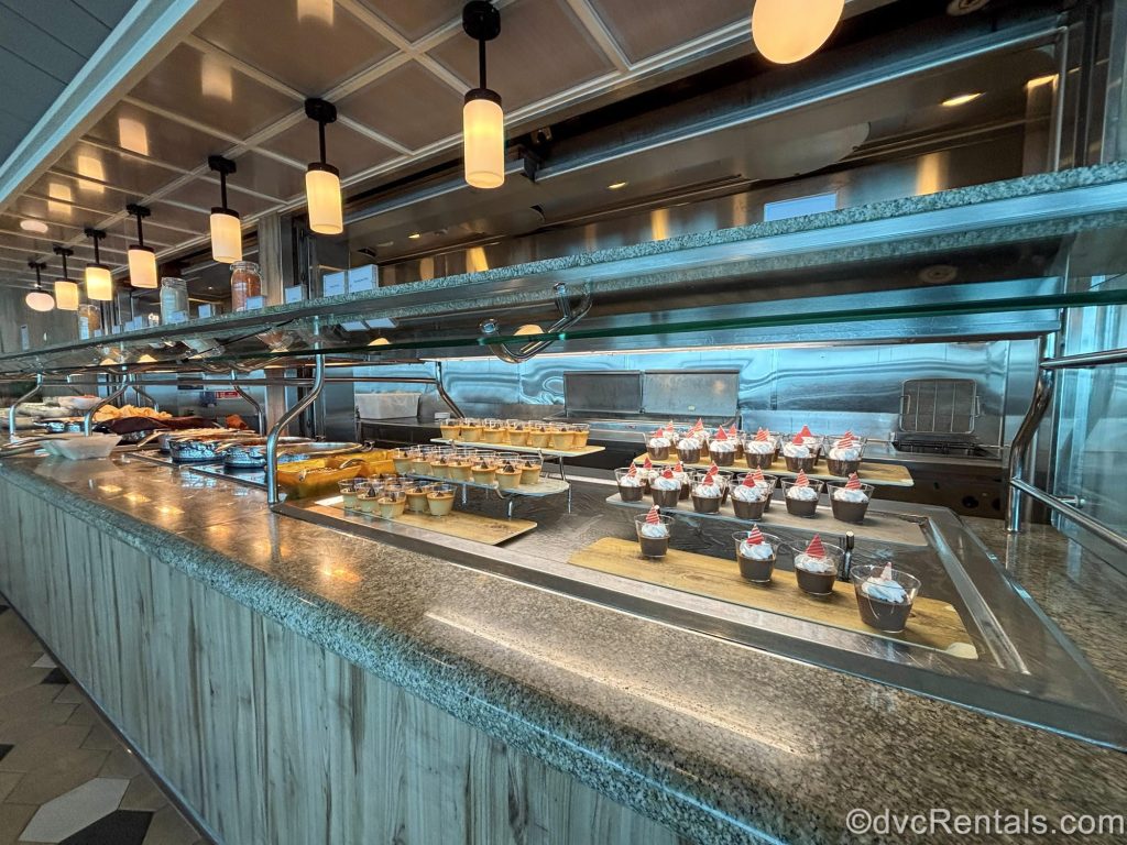 Trays of various foods and desserts are seen along the buffet counter of the Windjammer Marketplace.