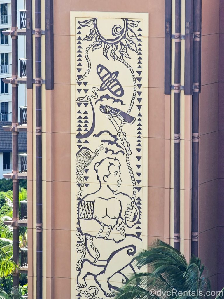 A large mural of Hawaiian art is seen displayed on an exterior portion of Aulani’s resort building.