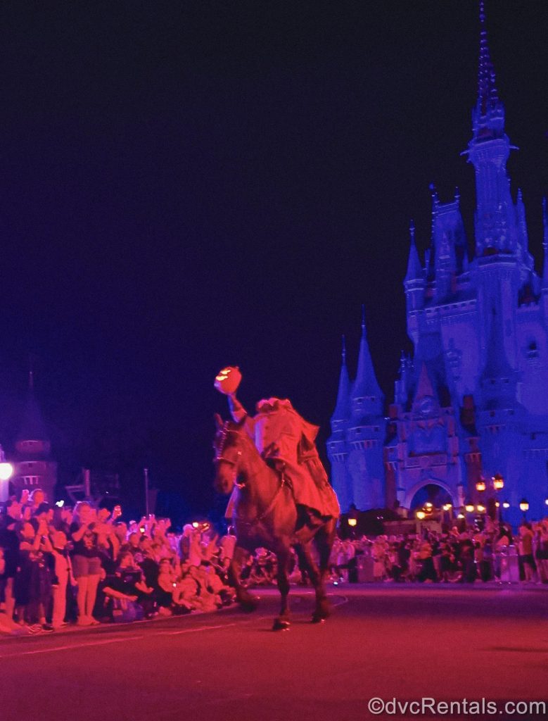 The Headless Horseman is illuminated with red light as he rides down Main Street U.S.A. as part of Mickey’s Boo-To-You Halloween Parade.