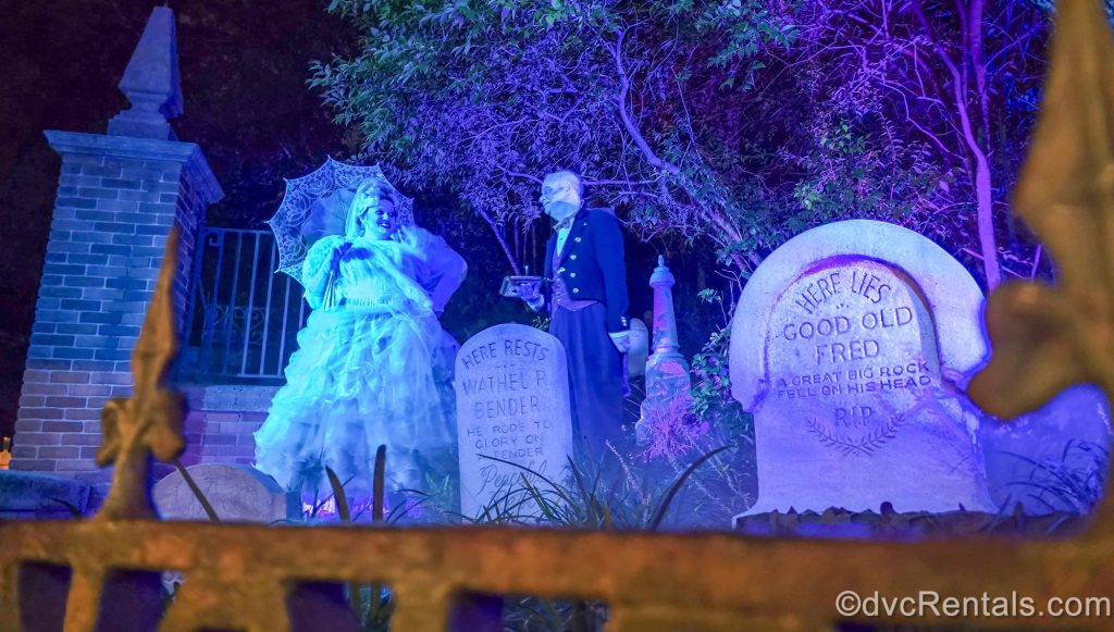 Haunted Mansion characters in spooky costumes interact with guests waiting in queue for the attraction at Magic Kingdom during Mickey’s Not-So-Scary Halloween Party.