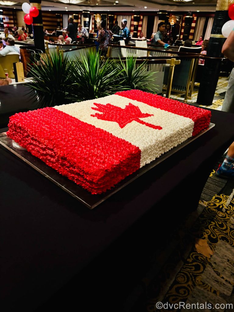 A large cake decorated with red and white icing to look like the Canadian flag is seen at a Canada Day celebration onboard Independence of the Seas.
