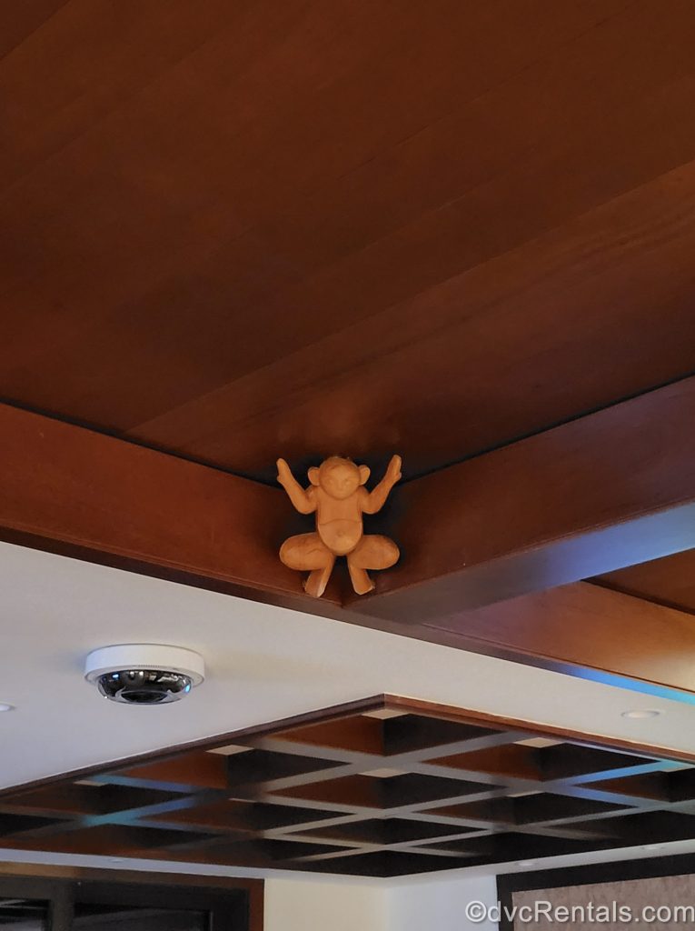 A wood-carved Menehune figure is seen hidden in the dark wood ceiling of the Ewa Tower at Aulani, a Disney Resort & Spa in Hawaii.